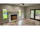 Spacious living room with a fireplace, hardwood floors, and access to the screened in deck at 1536 Copperwood Pl, Carmel, IN 46033