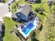 Sprawling backyard featuring a pool, patio, firepit, and meticulous landscaping at 15378 Dorman Ct, Fishers, IN 46040