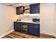 A stylish basement bar area with custom cabinetry and modern appliances at 15378 Dorman Ct, Fishers, IN 46040