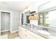 Bright bathroom featuring a double vanity, granite countertop, and access to a walk-in closet at 15378 Dorman Ct, Fishers, IN 46040
