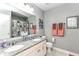 Bathroom featuring double vanity, granite countertop, and framed mirror over stylishly patterned shower curtain at 15378 Dorman Ct, Fishers, IN 46040