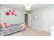 A charming bedroom features a cozy bed, floral wall decor, and plenty of natural light at 15378 Dorman Ct, Fishers, IN 46040