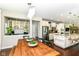 Elegant dining room with a rustic wood table and view into the kitchen at 15378 Dorman Ct, Fishers, IN 46040