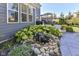 Landscaped backyard garden area with a small water feature, lush plants, and a stone pathway at 15378 Dorman Ct, Fishers, IN 46040