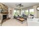 Bright living room with stone fireplace, large gray sectional, and an abundance of natural light at 15378 Dorman Ct, Fishers, IN 46040