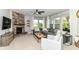 Cozy living room featuring a stone fireplace, plush sectional sofa, and abundant natural light at 15378 Dorman Ct, Fishers, IN 46040