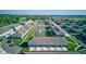 Drone view of a townhome community boasting serene water features and beautifully landscaped common areas at 17237 Rancorn Pl, Westfield, IN 46074