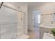 Bathroom featuring a glass-enclosed shower, double sinks, and neutral tile flooring at 17237 Rancorn Pl, Westfield, IN 46074
