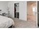 Light-filled bedroom with closet, desk, neutral carpet, and view to an open-concept hallway at 17237 Rancorn Pl, Westfield, IN 46074
