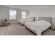Spacious bedroom with two twin beds, soft carpet, and natural light from the windows at 17237 Rancorn Pl, Westfield, IN 46074