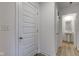 Hallway with neutral walls, hardwood floors, a closet, and a view into the powder room at 17237 Rancorn Pl, Westfield, IN 46074