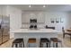Modern kitchen featuring an island with seating, stainless steel appliances, and gray cabinetry at 17237 Rancorn Pl, Westfield, IN 46074