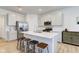 Modern kitchen featuring a large island with bar stools, stainless steel appliances, and white cabinetry at 17237 Rancorn Pl, Westfield, IN 46074