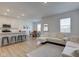 Inviting living space with hardwood floors, comfortable seating, and a smooth transition to the kitchen at 17237 Rancorn Pl, Westfield, IN 46074