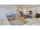 Open-concept living area featuring hardwood floors, a modern sofa, and seamless flow into the kitchen at 17237 Rancorn Pl, Westfield, IN 46074