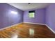 Bedroom with hardwood floors, natural light, and purple walls at 1760 Pumpkinvine Hill Rd, Martinsville, IN 46151