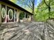 Spacious wood deck with wood railing overlooks the landscaped yard and features double doors at 1760 Pumpkinvine Hill Rd, Martinsville, IN 46151