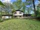 Two-story home with attached two-car garage and wood deck surrounded by mature trees at 1760 Pumpkinvine Hill Rd, Martinsville, IN 46151