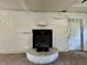 Close up of the wood burning fireplace with white brick surround at 1760 Pumpkinvine Hill Rd, Martinsville, IN 46151