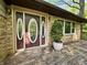 Charming front porch with a wooden deck and a front door with oval windows at 1760 Pumpkinvine Hill Rd, Martinsville, IN 46151