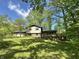 Two-story home with a large front yard and a charming wooden deck at 1760 Pumpkinvine Hill Rd, Martinsville, IN 46151