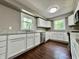 Updated kitchen features white cabinets, granite countertops, stainless steel appliances, and a window at 1760 Pumpkinvine Hill Rd, Martinsville, IN 46151