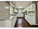 Galley kitchen with white cabinets, stainless steel appliances, and hardwood floors at 1760 Pumpkinvine Hill Rd, Martinsville, IN 46151
