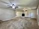 Open-concept living room featuring a painted brick fireplace and neutral carpeting at 1760 Pumpkinvine Hill Rd, Martinsville, IN 46151