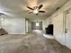 Large living area with fireplace, carpet flooring, and multiple windows for ample light at 1760 Pumpkinvine Hill Rd, Martinsville, IN 46151