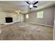 Spacious living room with painted brick fireplace, carpet, and natural light from windows at 1760 Pumpkinvine Hill Rd, Martinsville, IN 46151