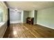 Open living room with hardwood floors, piano, and large windows letting in natural light at 1760 Pumpkinvine Hill Rd, Martinsville, IN 46151