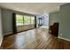 Bright living room with hardwood floors, piano, and view of trees at 1760 Pumpkinvine Hill Rd, Martinsville, IN 46151