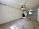 Spacious living room with a cozy fireplace, ceiling fans, and neutral colored carpet at 1760 Pumpkinvine Hill Rd, Martinsville, IN 46151
