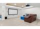 Finished basement featuring a home theatre setup with a projector, screen and brown leather sofa at 1787 Halifax St, Carmel, IN 46032