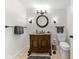 Bathroom with antique vanity, dark fixtures, and black towel racks on tiled floor at 1787 Halifax St, Carmel, IN 46032