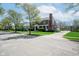 Brick house with mature trees and lawn, featuring a side-entry garage and driveway at 1787 Halifax St, Carmel, IN 46032