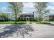 Lovely brick home with green lawn, blue shutters and door, flanked by mature trees at 1787 Halifax St, Carmel, IN 46032