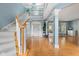 Bright foyer showcasing hardwood floors, staircase, white trim, and natural light at 1787 Halifax St, Carmel, IN 46032