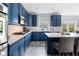 Kitchen with white countertops, backsplash, blue cabinets, and island with bar stool seating at 1787 Halifax St, Carmel, IN 46032
