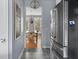 Kitchen with stainless steel refrigerator and view to a dining room with chandelier at 1787 Halifax St, Carmel, IN 46032