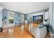 Sunlit living room with hardwood floors, blue walls, and dining area in the background at 1787 Halifax St, Carmel, IN 46032