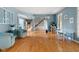 Spacious living room featuring hardwood floors, blue accent walls, and staircase at 1787 Halifax St, Carmel, IN 46032