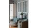 Stylish living room featuring two armchairs, decorative windows, and a white storage cabinet at 1787 Halifax St, Carmel, IN 46032