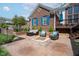 Charming brick patio with cozy seating around a stone fire pit, perfect for outdoor entertaining at 1787 Halifax St, Carmel, IN 46032