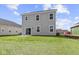The home's backyard features a spacious lawn and patio, offering plenty of room for outdoor activities at 1874 Victor Higgins Dr, Shelbyville, IN 46176