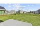 A spacious backyard features an enormous lawn with a concrete patio, ready for landscaping or recreation at 1874 Victor Higgins Dr, Shelbyville, IN 46176