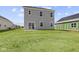 The home's backyard showcases a spacious lawn and patio, with a lot of room for outdoor activities at 1874 Victor Higgins Dr, Shelbyville, IN 46176