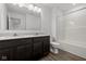 Bathroom with double sink vanity, large mirror, and bathtub with shower at 1874 Victor Higgins Dr, Shelbyville, IN 46176