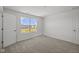 Bedroom with neutral carpet, white walls, and window overlooking a neighborhood street at 1874 Victor Higgins Dr, Shelbyville, IN 46176