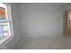Bright, blank bedroom ready for customization, featuring a window and an open doorway to the rest of the home at 1874 Victor Higgins Dr, Shelbyville, IN 46176